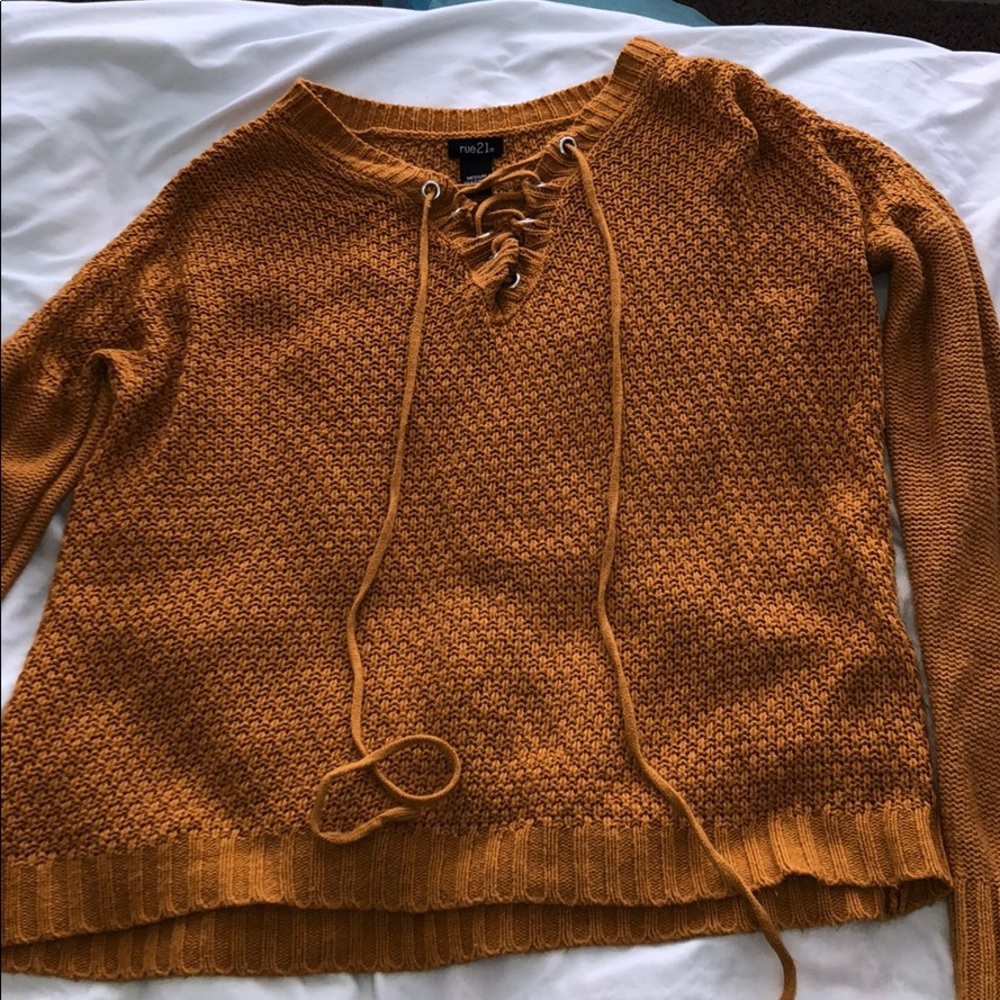 yellow sweater with ties on the front